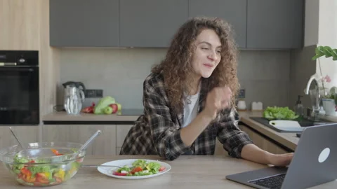 Waving Hello On Video Call While Standing In Cozy Kitchen With Fresh Salad 스톡 동영상 311269670