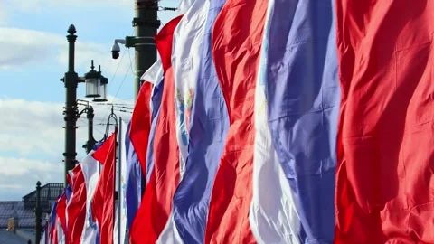 Waving holiday flags on the Palace bridge. Colorful fabrics on the street Stock Footage 274673822