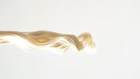 Waving of locks of blond shiny wavy bunch hair. Slow Motion. Hair care and 動画素材 256922113