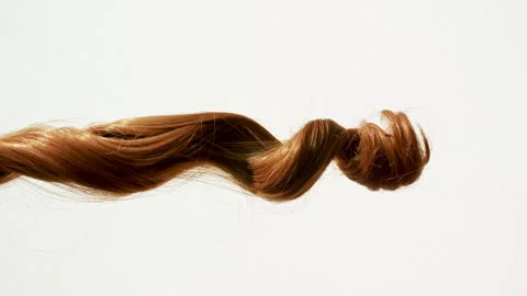 Waving of locks of brown bunch shiny wavy hair. Slow Motion. Hair care and Stock-Footage 262781442