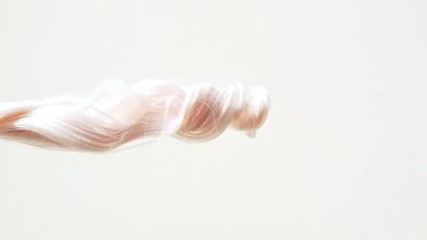 Waving of locks of pink shiny wavy bunch hair. Slow Motion. Hair care and beauty Video stock 272591634