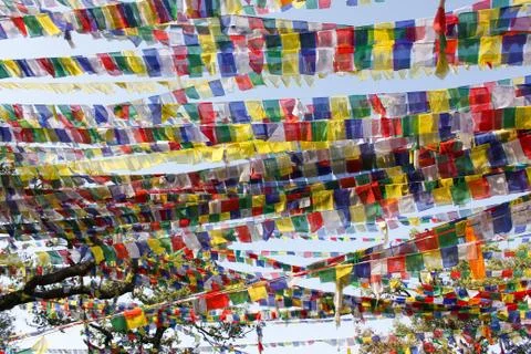Waving multi-colored prayer flags in a buddhist temple Stock Photos
