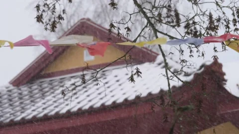 Waving Prayer Flags in Winter Weather, Buddhist Temple in Background, Close up Stock Footage 231618792