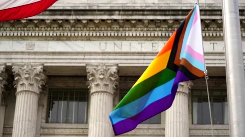 Waving Pride flag next to the flag of USA Video stock 156511656