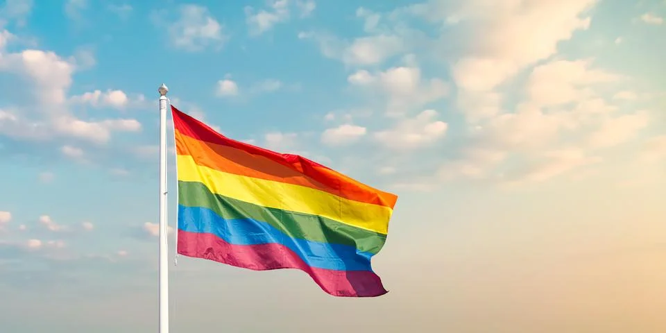 Waving rainbow flag with pole Stock Photos