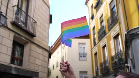 Waving rainbow pride flags in a narrow european street Stock Footage 318828304
