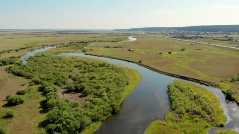 Waving river of blue colour surrounded by forests and fields Stock Footage 139860871