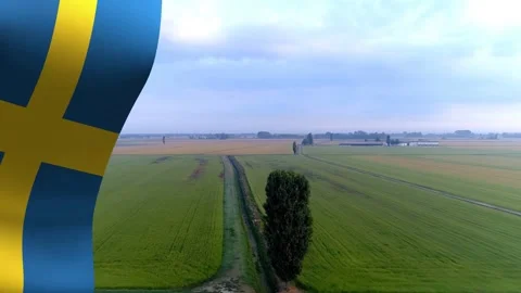 Waving Swedish flag overlaying left edge starting aerial pull moving to lone Stock Footage 335212181