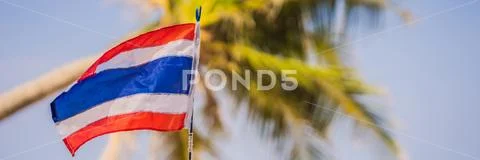 Waving Thailand flag in the sunny blue sky with summer beach background Stock Photos