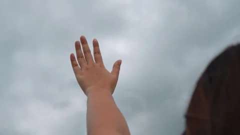 Waving towards heavy storm clouds and an approaching rainstorm. Stock Footage 316568040