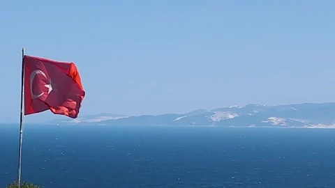 Waving Turkish Flag and Distant View of Marmara Island on a Sunny Day Stock Footage 322993717