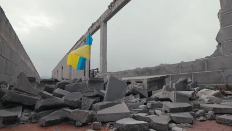 Waving Ukraine flag on the building destroyed in war by russia Stock Footage 171608693
