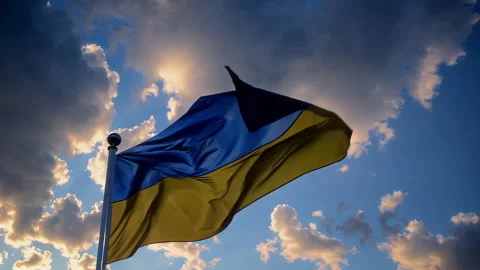 Waving the Ukrainian Flag Against a Dramatic and Stunning Sky, Filled with Stock Footage 306176175