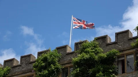 Waving Union Jack Flag on castle roof Stock Footage 111559703