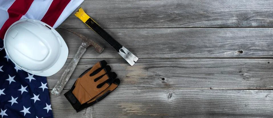 Waving US flag with construction tools on weathered wooden background for Lab Stock Photos