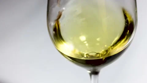 Waving white wine in a glass on white background. Stock Footage 152953653
