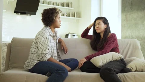 Waving your hands around while talking. Two girlfriends, an African-American and Stock Footage 162382884