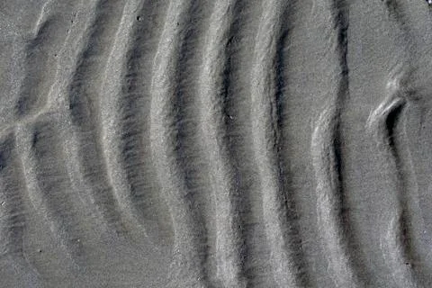 Wavy beach sand background, vertical waves, close up Stock Photos