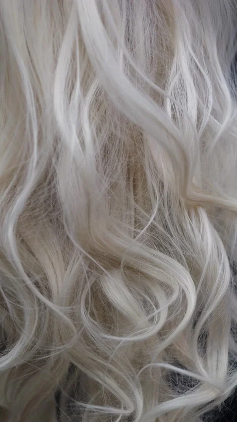 Wavy blond hair covers the screen with curls. Perfect for textured backgrou.. Stock Footage 279548331