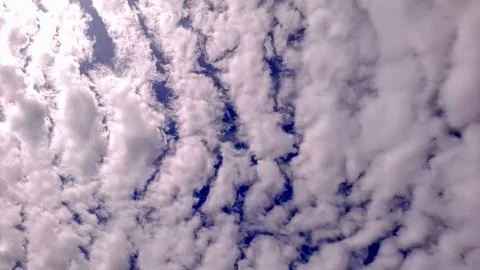 Wavy Cloud Pattern in Blue Sky with Soft Purple Tint Foto stock