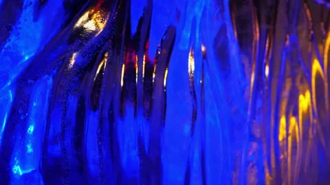 Wavy ice block with small air bubbles glows blue, abstract blurred background Stock Footage 212338423