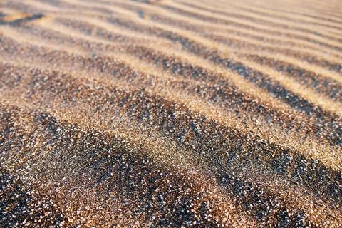 Wavy marking formed by the action of wind on the sand of a beach Stock Photos
