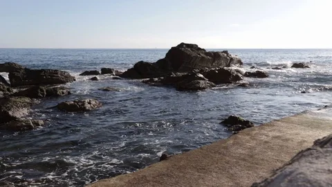 Wavy motion on rocks and low wall Stock Footage 102295198