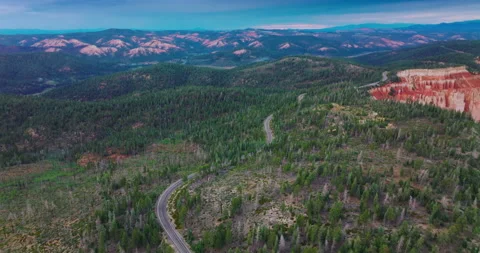 Wavy motorway passing the pine woods covering the mountains.  Stock Footage 212974290