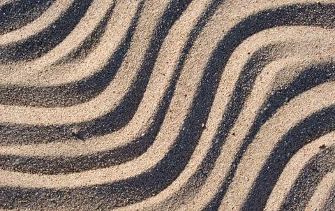Wavy pattern of natural beach sand background for summer designs Stock Photos
