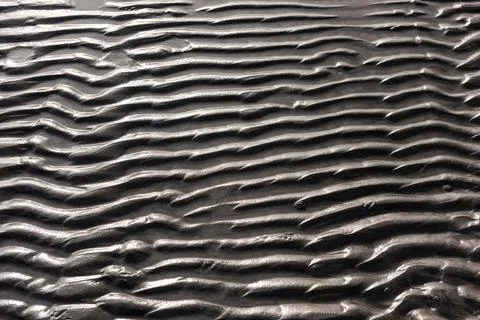 Wavy pattern of sand on a beach Stockfoto's