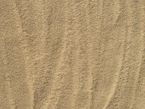 Wavy patterns on the sand texture. Sandy arid background. Stock Photos