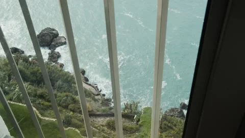 The wavy sea is seen through the window bars 動画素材 141777525