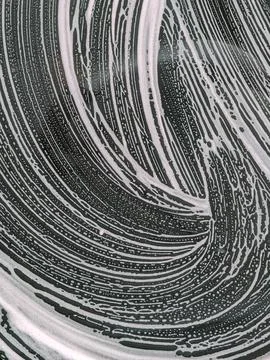 Wavy soap foam pattern on car window Stock Photos
