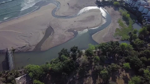 Wavy stream goes toward the ocean waves water reflection view aerial footage Stock Footage 100692326