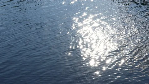 Wavy surface of blue river water with sun light reflections Stock Footage 238987952