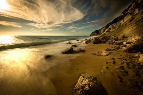 Wavy turquoise ocean on the left in the background with blue sky above. Beaut Stock Photos