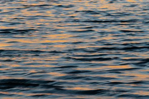 Wavy water surface during sunset Stock Photos