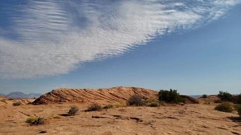 Wavy White Clouds Over Wavy Sandstone Rocks Stock Footage 115801615