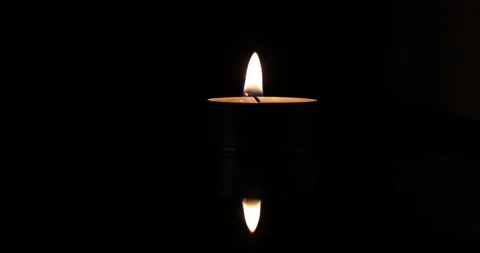 Wax candle flame light glowing jumping throbbing dancing flickering in the da Stock Footage 172425326