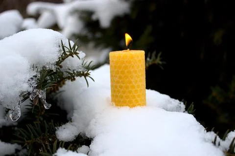 A wax candle with a flame Stock Photos