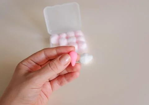Wax earplug in hand. A drop was made from a ball Stock Photos
