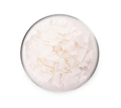 Wax flakes in glass bowl on white background, top view. Homemade candle mater Stock Photos