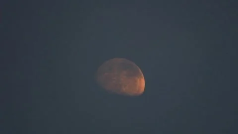 Waxing Gibbous Moon Emerging From Thin Passing Clouds in Dark Sky Видео 345110474