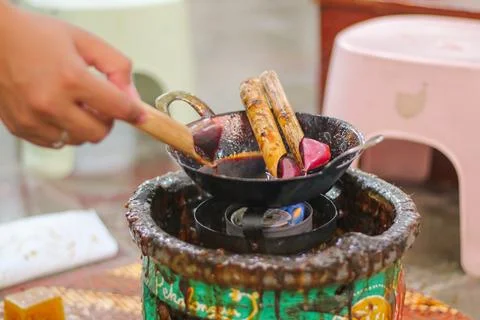 Waxing process of batik painting using brush and malam Stock Photos
