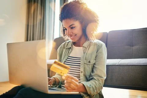 This is way better than standing in a queue. a cheerful young woman doing online Stock Photos