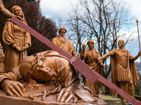 Way of the cross-Jesus falls a third time under the cross. Stock Photos