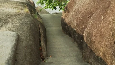 Way to shore between huge rocks on tropical beach Stock Footage 331062125