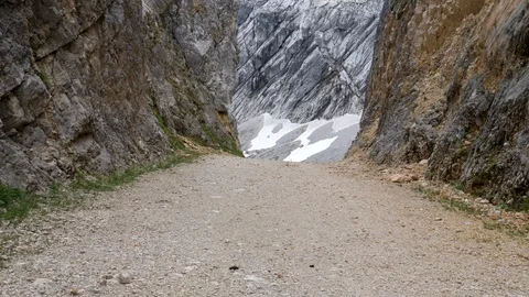 A way through mountains with rock faces on both sides Stock Footage 121005421