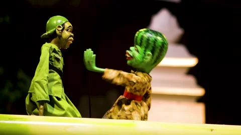 Wayang golek puppet with watermelon painted head making expressive hand ges.. Stock Footage 344796858