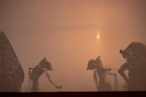 Wayang Kulit Puppet Ensemble Behind Warm Shadow Screen Stock Photos